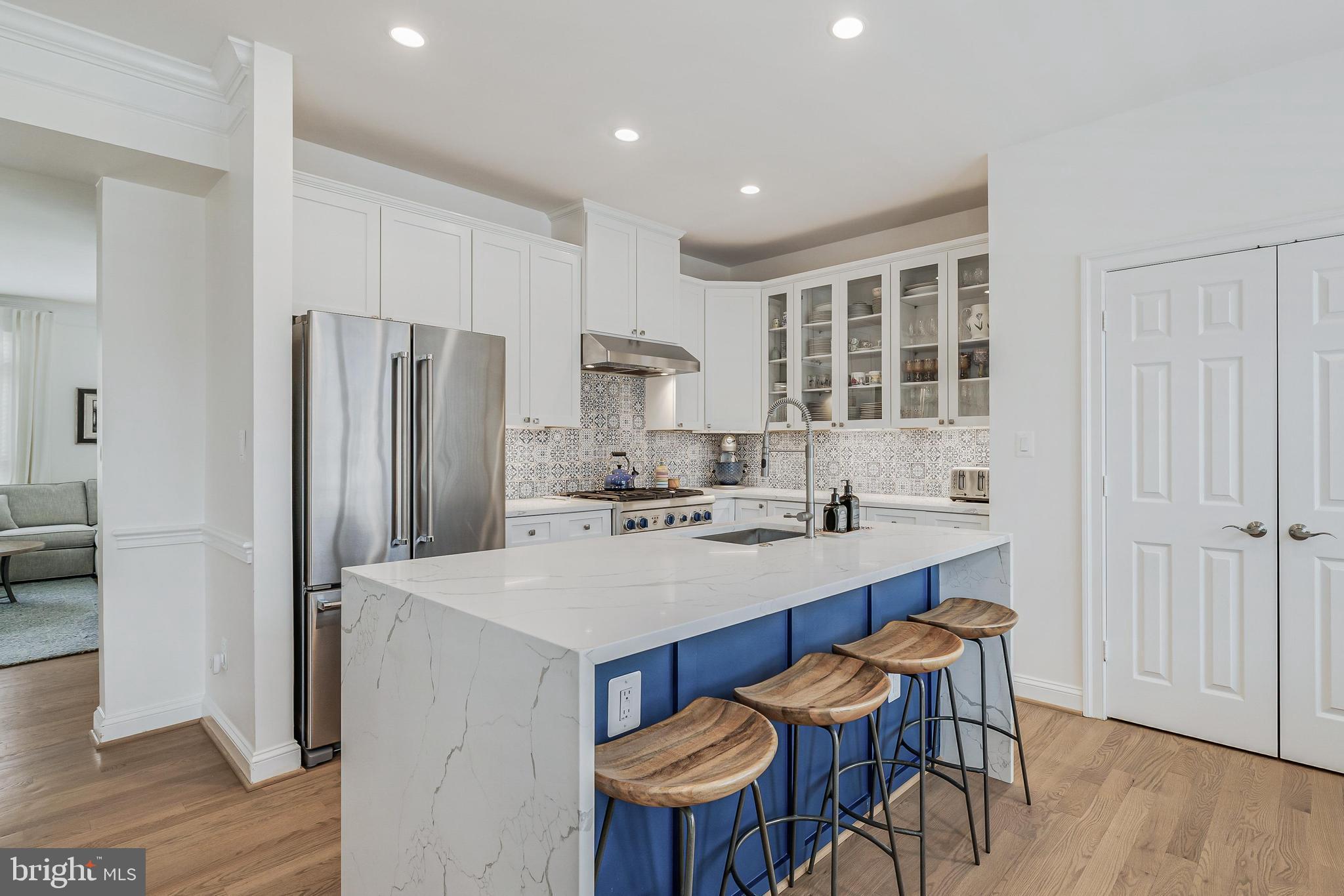 11408 Summer House Court Reston, VA 20194 - Photo 7 of 35 a kitchen with stainless steel appliances a table and chairs