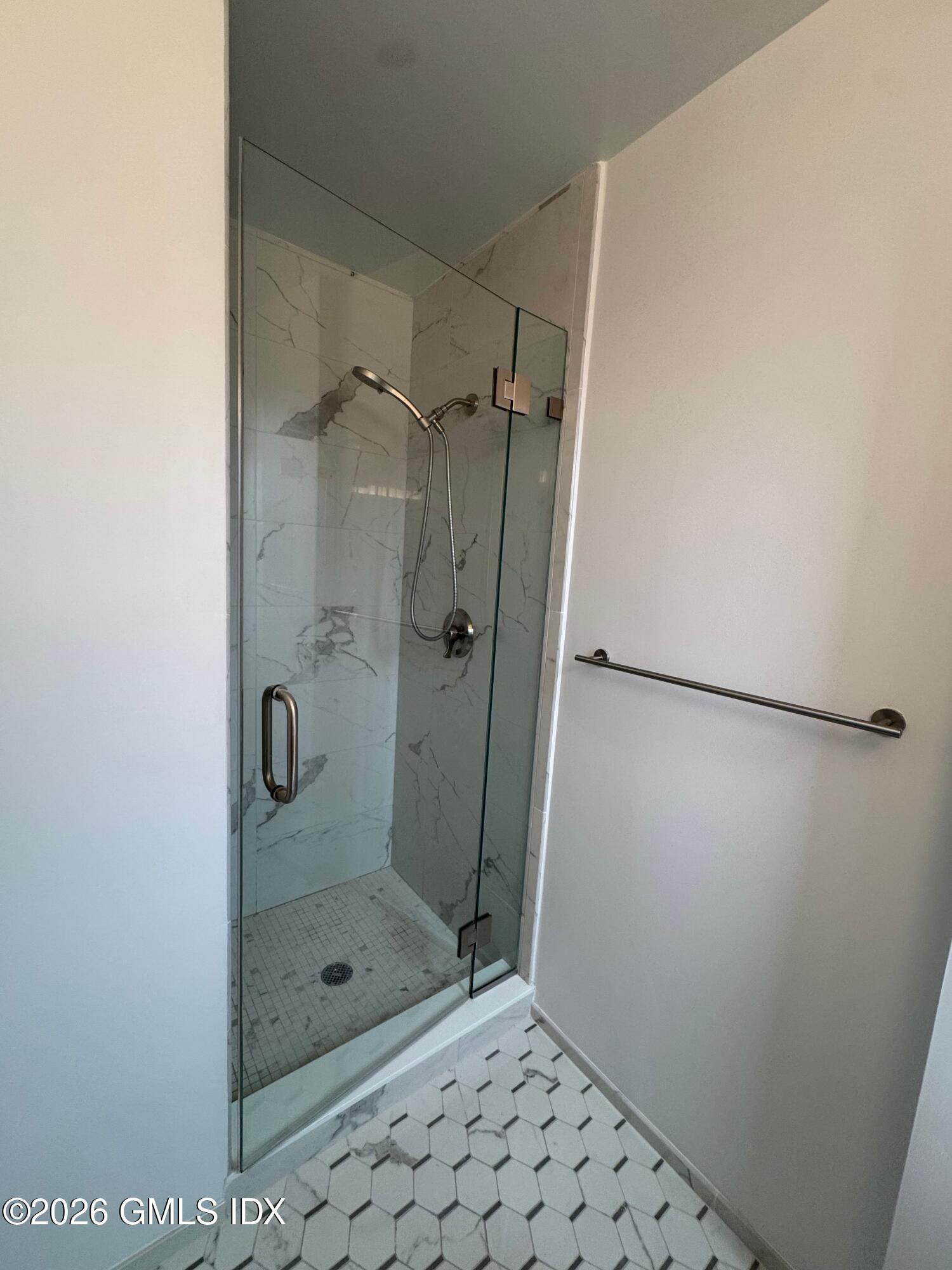 25 West Elm Street, Unit 40 Greenwich, CT 06830 - Photo 27 of 28 a bathroom with a glass shower door