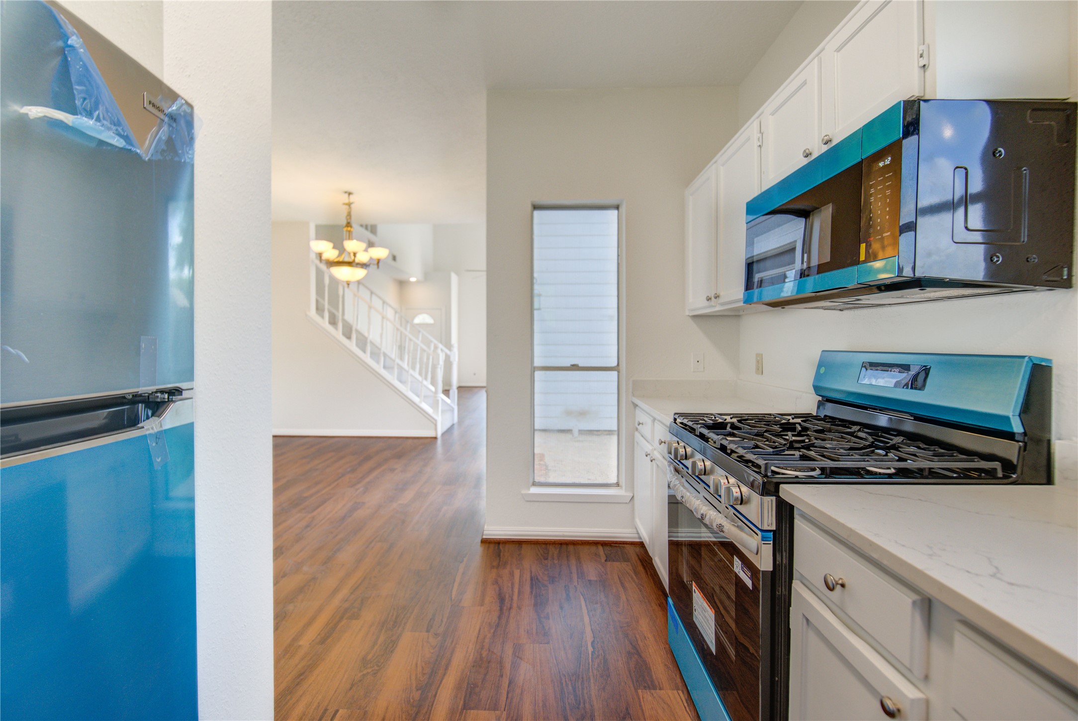 308 North Ranch House Road Angleton, TX 77515 - Photo 16 of 38 Ample cabinet space and dual windows provide plenty of natural light, creating a functional and inviting cooking space.