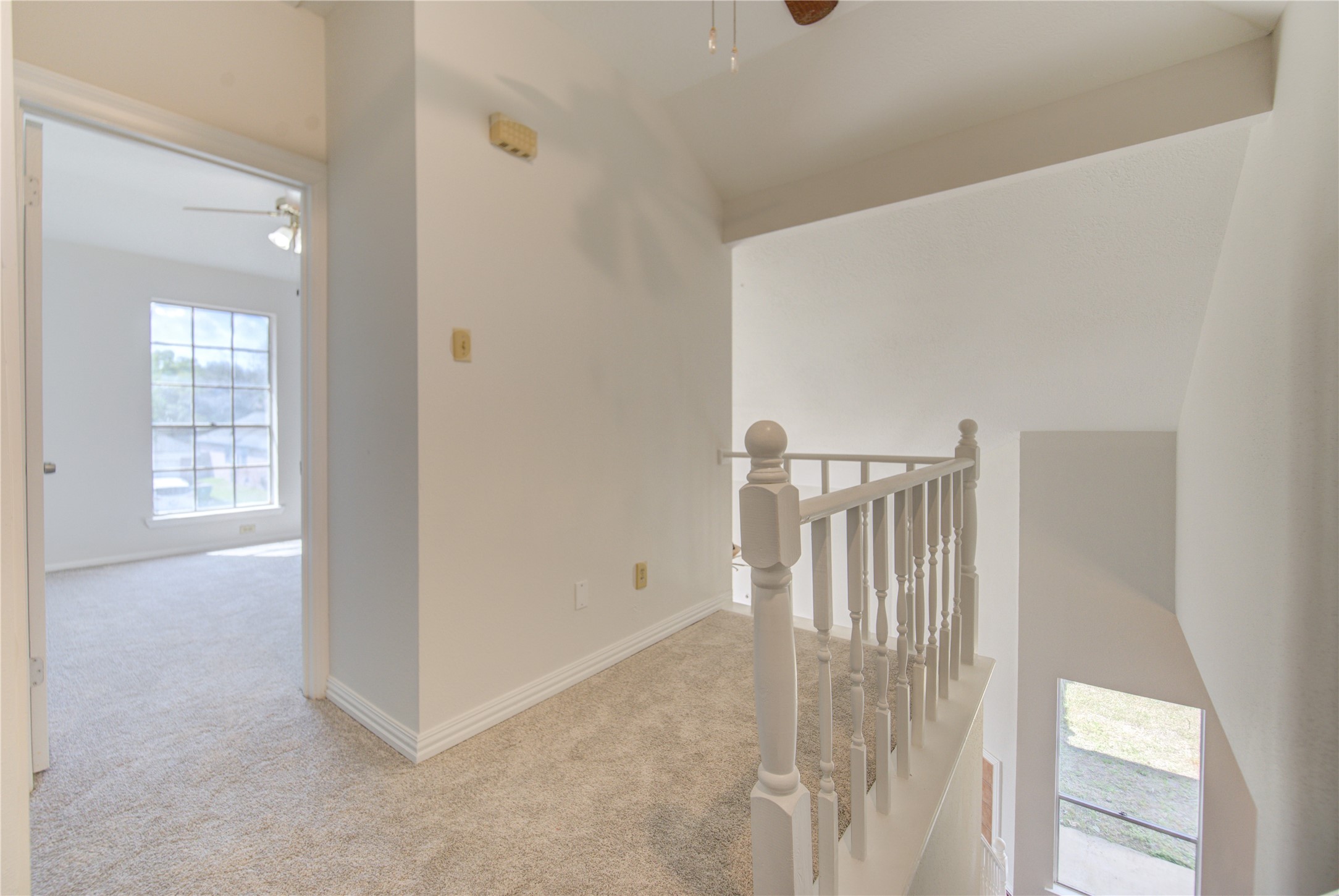 308 North Ranch House Road Angleton, TX 77515 - Photo 27 of 38 Bright upstairs landing with soft carpeting and open railing overlooking the main living area. This space offers additional flexibility for a reading nook, study area, or workspace.
