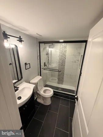 a bathroom with a toilet a sink and a shower