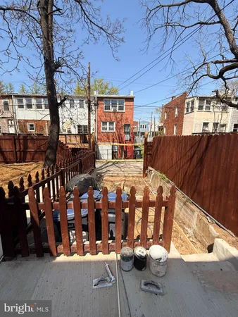 a view of a house with wooden fence