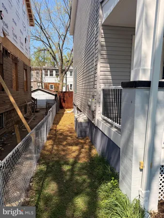 a backyard of a house with barbeque oven and outdoor seating