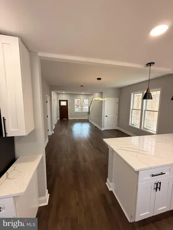 a kitchen with sink cabinets and wooden floor