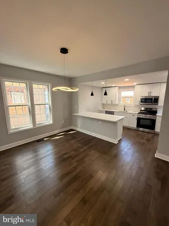 a kitchen with granite countertop a stove and cabinets