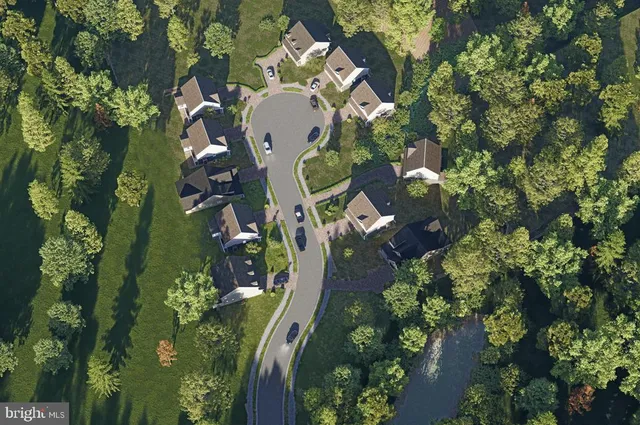 an aerial view of a house with a yard and garden