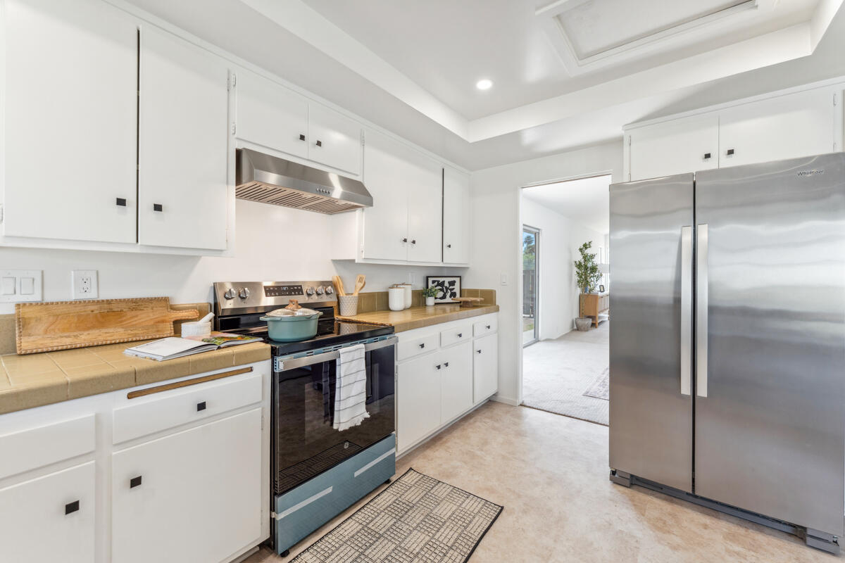 7286 Georgetown Road Goleta, CA 93117 - Photo 16 of 19 a kitchen with stainless steel appliances granite countertop a stove a sink and a refrigerator