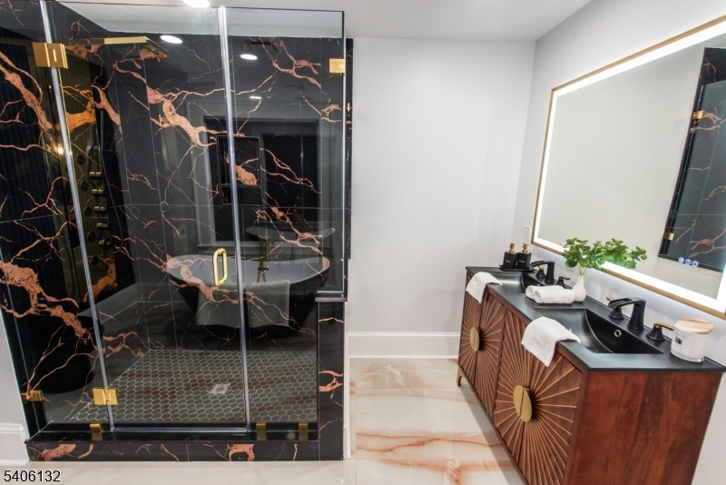 570 Cameron Road South Orange, NJ 07079 - Photo 21 of 34 a bathroom with a sink a mirror and shower