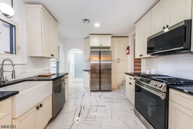 a view of a room with wooden floor and a bathroom