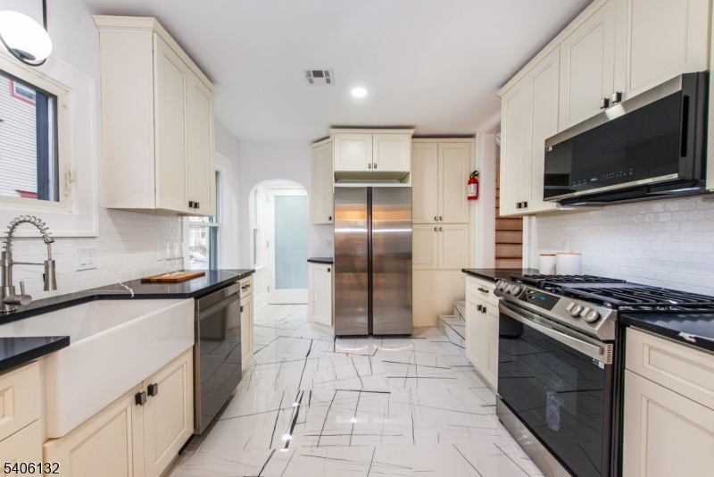 570 Cameron Road South Orange, NJ 07079 - Photo 4 of 34 a kitchen with stainless steel appliances granite countertop a stove a sink and a microwave