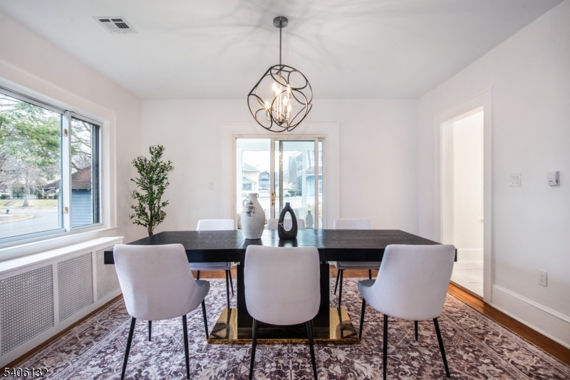 570 Cameron Road South Orange, NJ 07079 - Photo 10 of 34 a dining room with furniture a chandelier and wooden floor