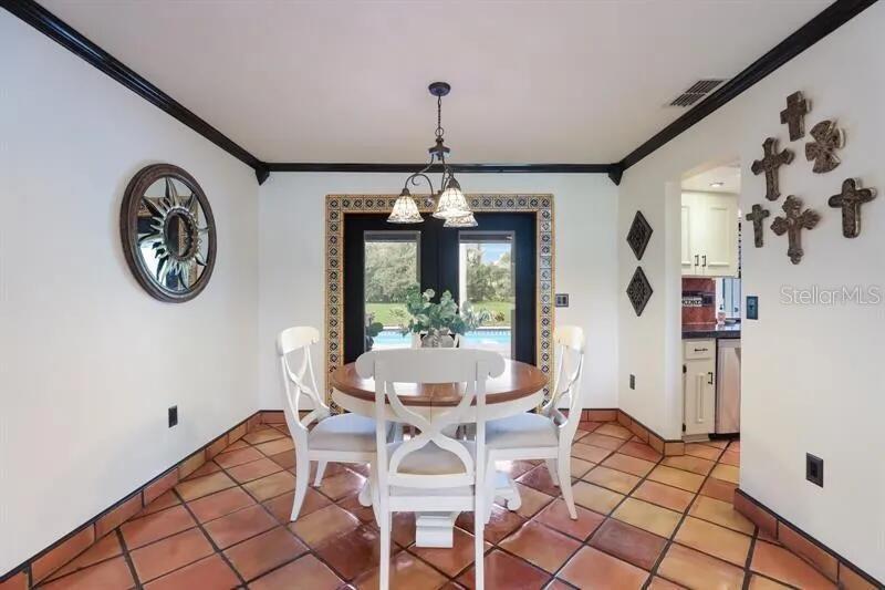 2077 Racimo Drive Sarasota, FL 34240 - Photo 12 of 12 a view of a dining room with furniture window and outside view