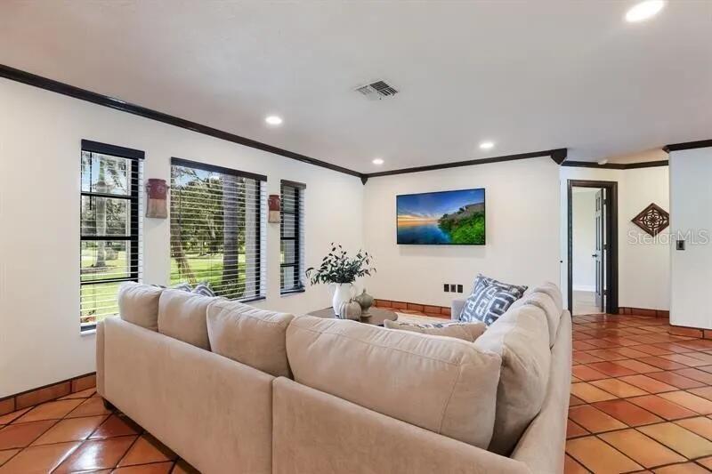 2077 Racimo Drive Sarasota, FL 34240 - Photo 2 of 12 a living room with furniture and a flat screen tv