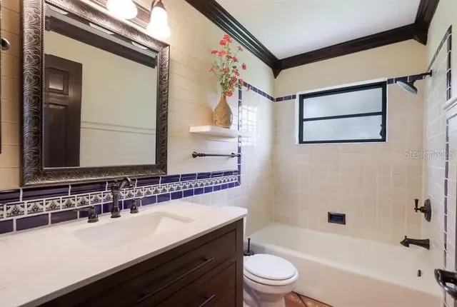 a bathroom with a bathtub a sink and a large mirror