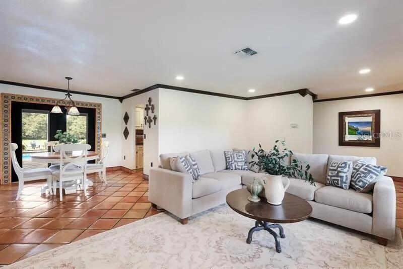 2077 Racimo Drive Sarasota, FL 34240 - Photo 7 of 12 a living room with furniture and a large window