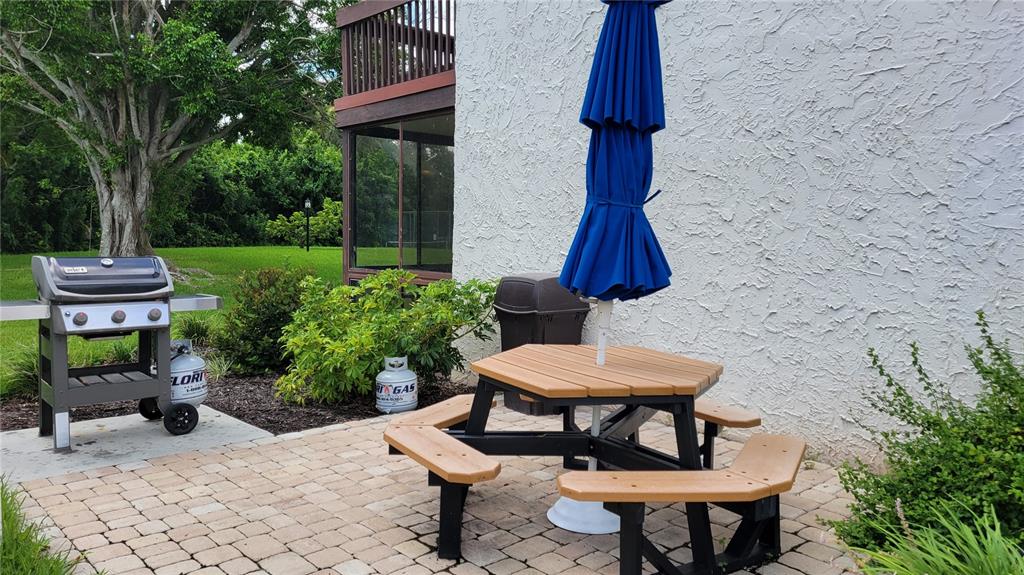 1626 Stickney Point Road, Unit 102 Sarasota, FL 34231 - Photo 13 of 42 a view of a chairs and table in backyard