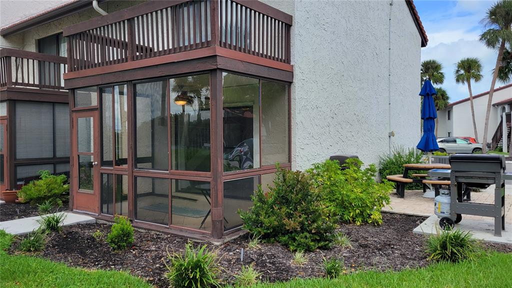 1626 Stickney Point Road, Unit 102 Sarasota, FL 34231 - Photo 14 of 42 a view of a chair and table in backyard of the house