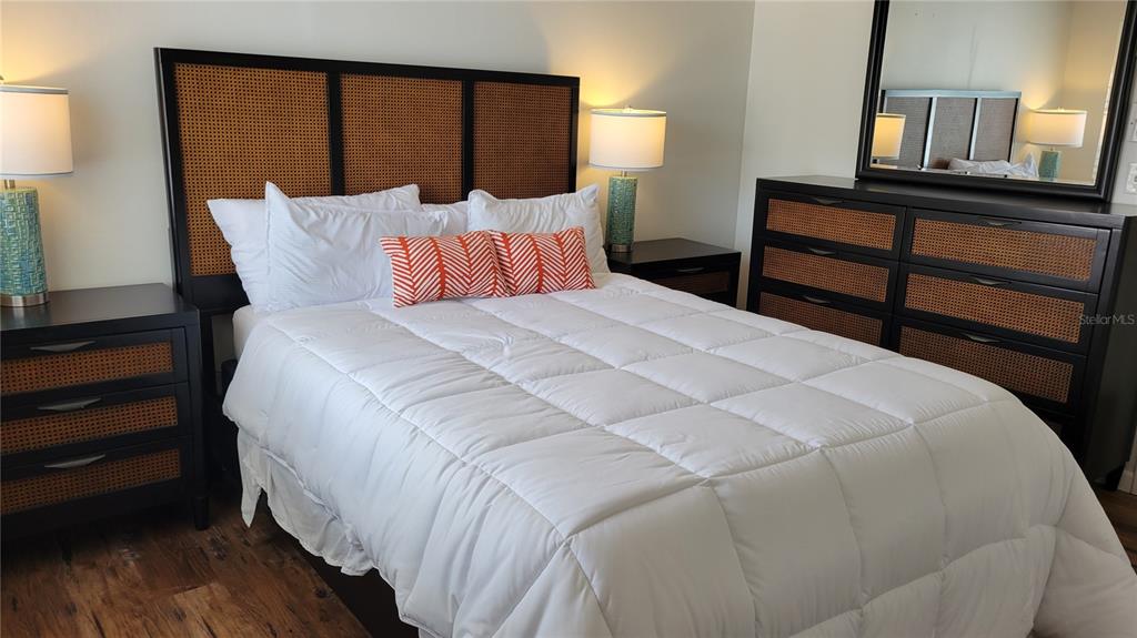 1626 Stickney Point Road, Unit 102 Sarasota, FL 34231 - Photo 15 of 42 a bedroom with a bed and a night stand