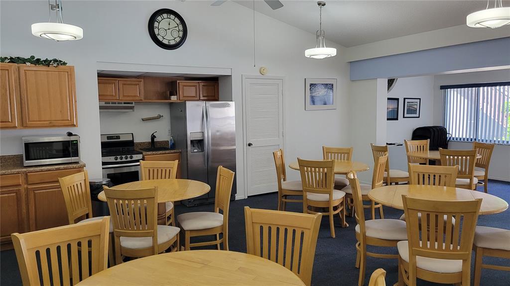 1626 Stickney Point Road, Unit 102 Sarasota, FL 34231 - Photo 25 of 42 a kitchen with a table chairs a stove a dining table and chairs