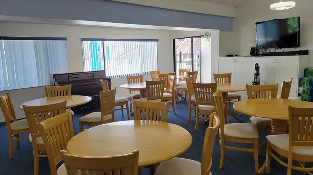 a view of a dining room with furniture window and outside view