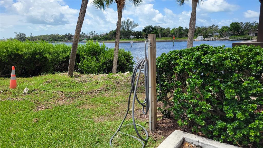 1626 Stickney Point Road, Unit 102 Sarasota, FL 34231 - Photo 28 of 42 a view of a garden with a lake
