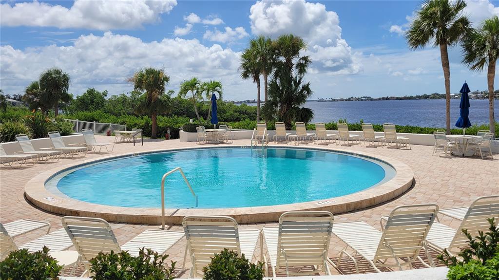 1626 Stickney Point Road, Unit 102 Sarasota, FL 34231 - Photo 34 of 42 a view of a swimming pool with a patio