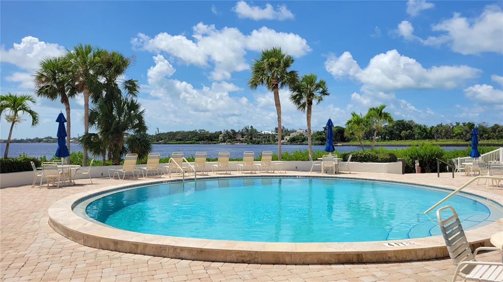 1626 Stickney Point Road, Unit 102 Sarasota, FL 34231 - Photo 36 of 42 a view of a swimming pool and lake view