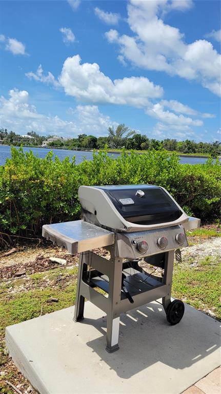 1626 Stickney Point Road, Unit 102 Sarasota, FL 34231 - Photo 37 of 42 a view of a swimming pool with lawn chairs
