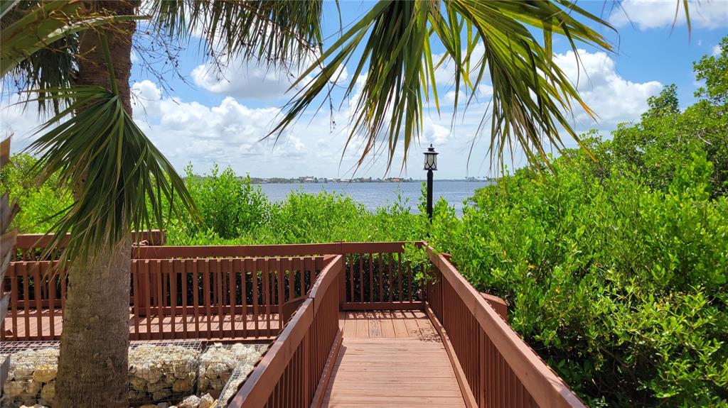 1626 Stickney Point Road, Unit 102 Sarasota, FL 34231 - Photo 39 of 42 a view of balcony with wooden floor and fence