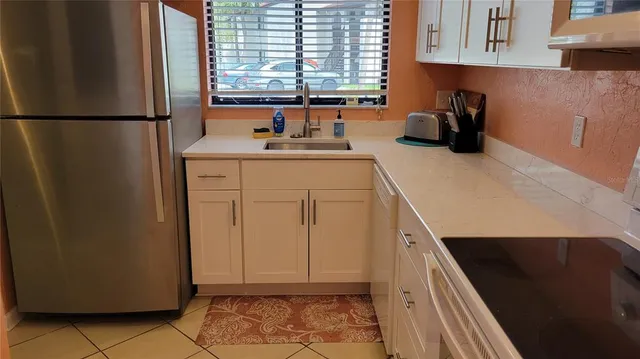 a kitchen with refrigerator and window