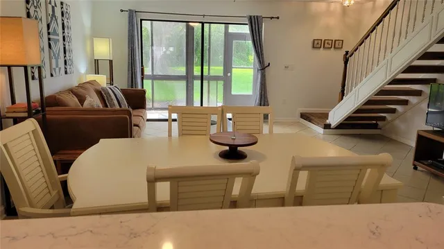 a living room with furniture and floor to ceiling windows