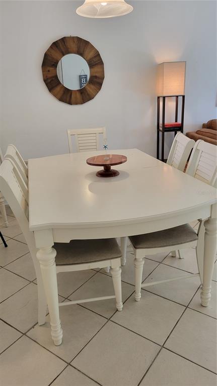 1626 Stickney Point Road, Unit 102 Sarasota, FL 34231 - Photo 7 of 42 a bedroom with a bed and a chandelier