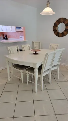 a dining room with furniture and chandelier