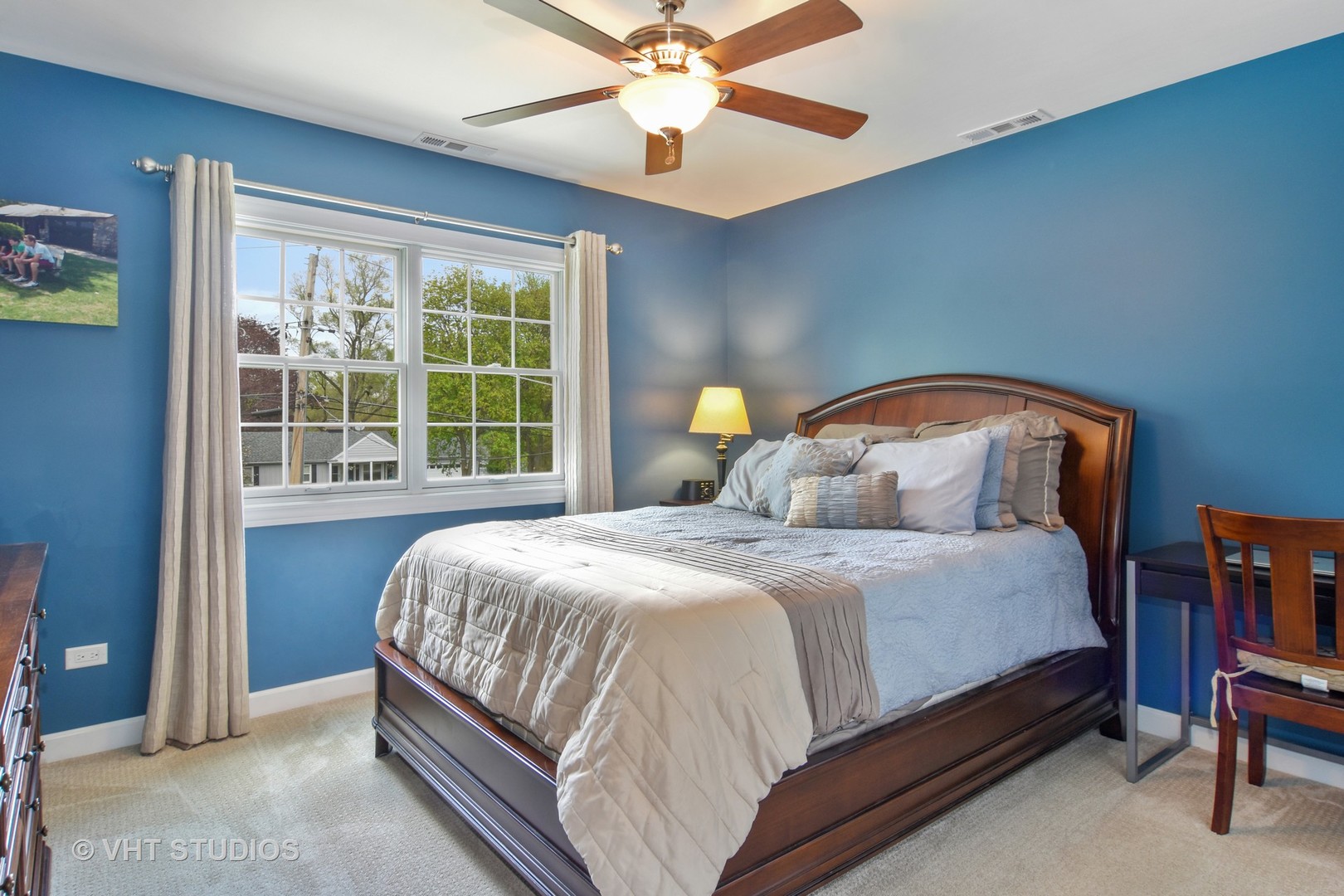 567 West Helen Road Palatine, IL 60067 - Photo 22 of 39 a bedroom with a bed lamp and a large window