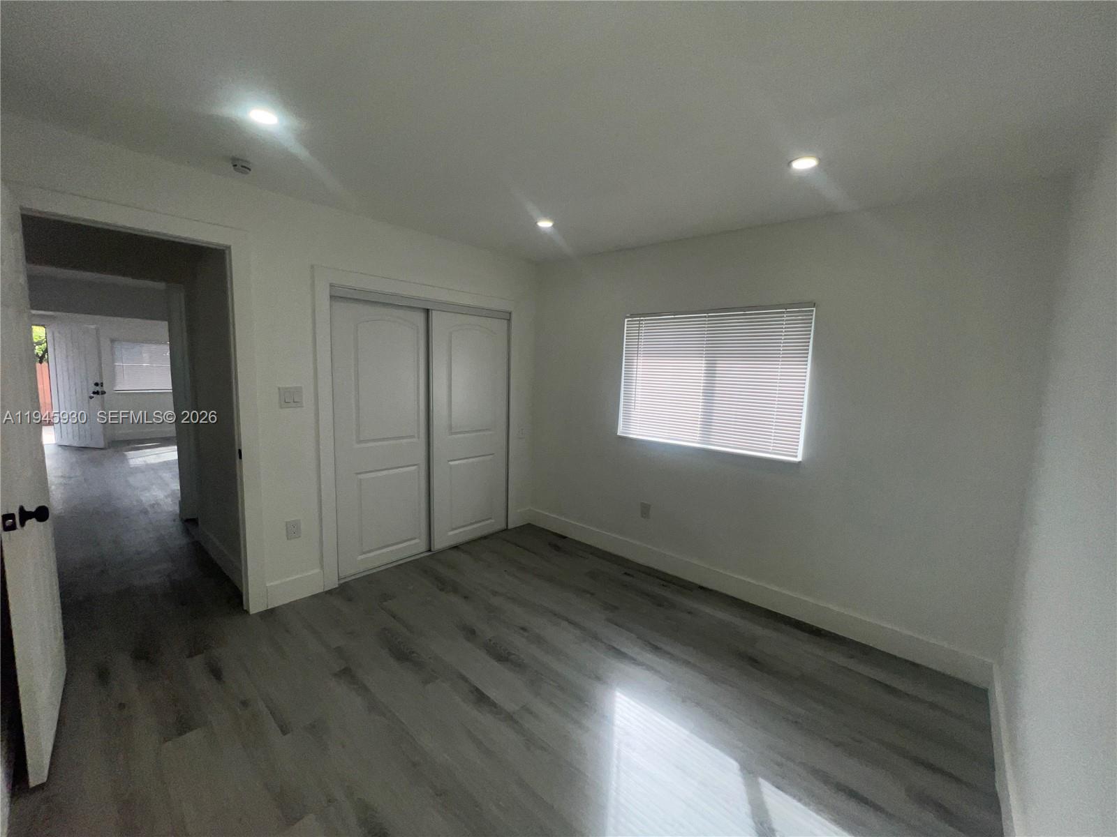 1800 Southwest 3rd Street, Unit D Miami, FL 33135 - Photo 14 of 27 an empty room with wooden floor and windows