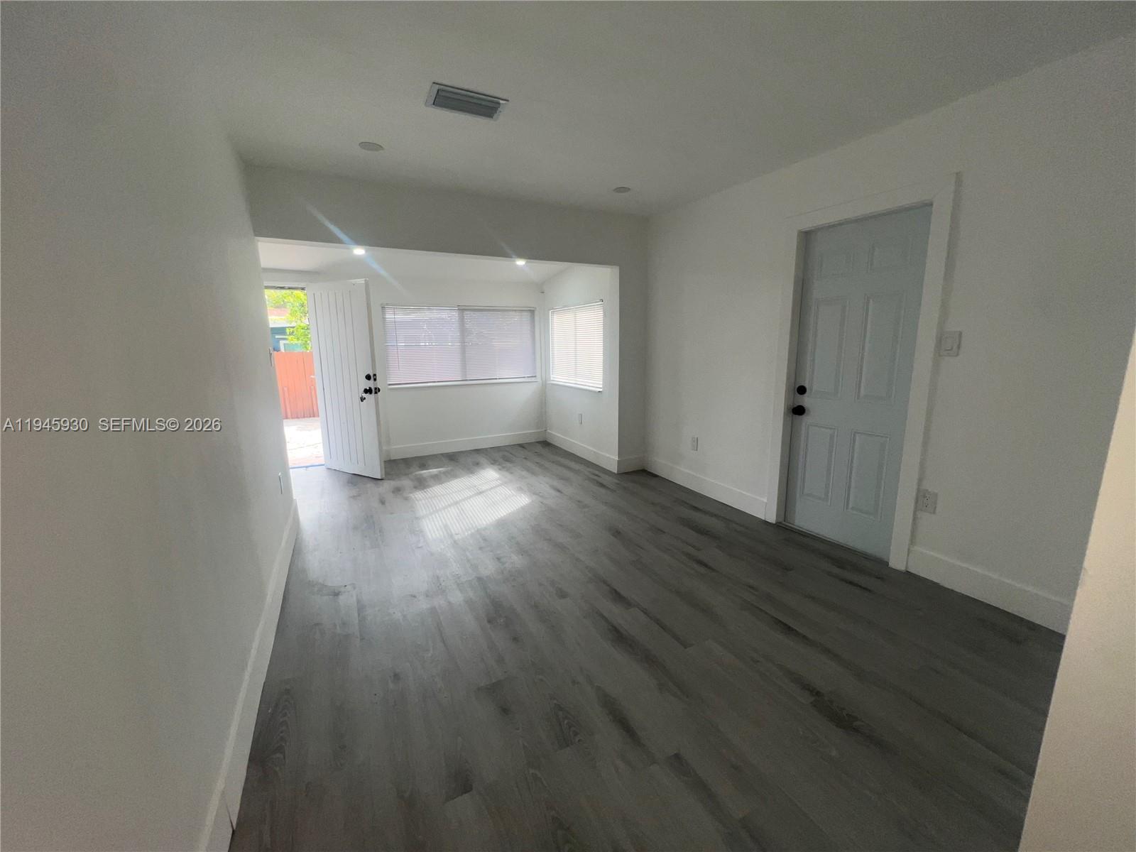 1800 Southwest 3rd Street, Unit D Miami, FL 33135 - Photo 22 of 27 wooden floor in an empty room with a window