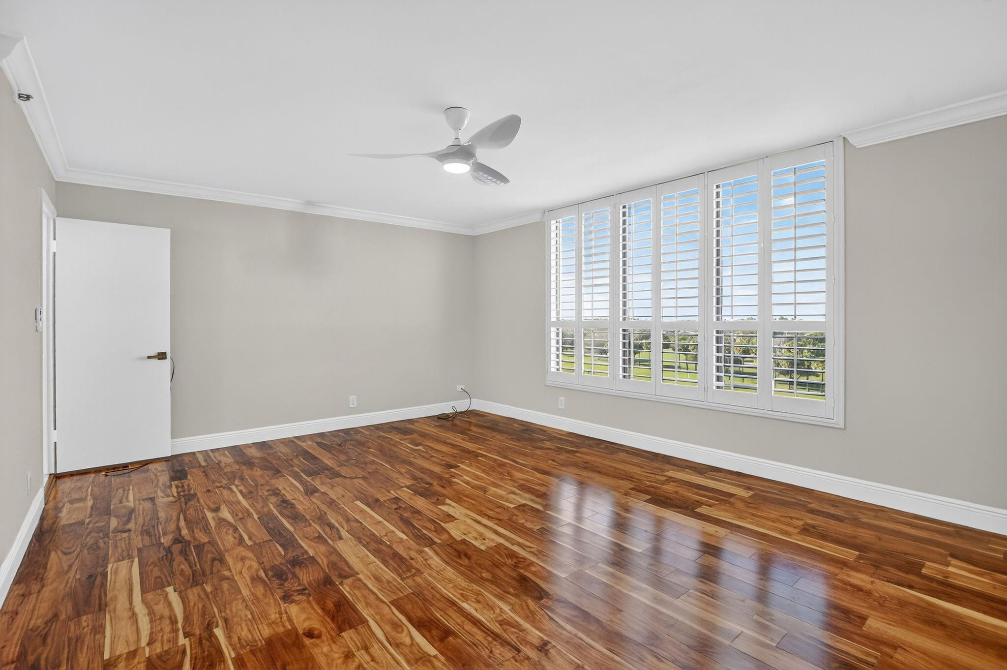 7145 Promenade Drive, Unit C702 Boca Raton, FL 33433 - Photo 47 of 82 a view of an empty room with wooden floor and a window