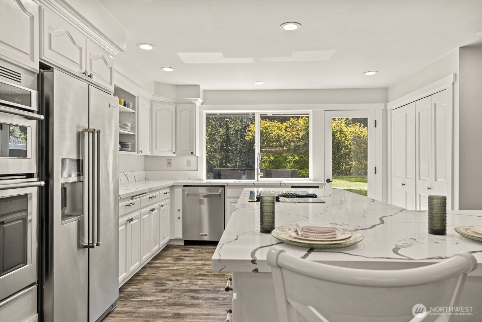 27605 Southeast Issaquah-Fall City Road Fall City, WA 98024 - Photo 8 of 39 a kitchen with stainless steel appliances granite countertop a refrigerator a sink a stove and island