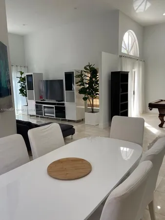 a living room with furniture a large window and a flat screen tv