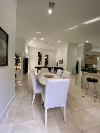 a large kitchen with a table and chairs