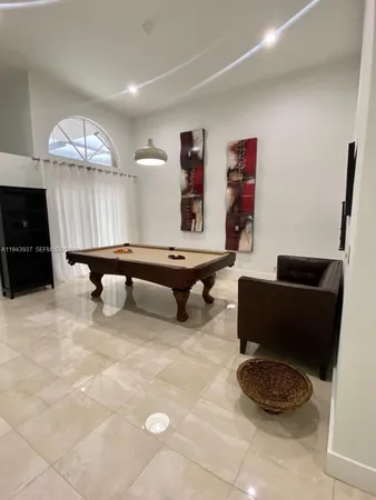 a living room with furniture piano and a table