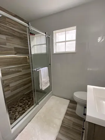 a bathroom with a toilet and a shower