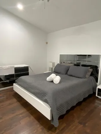 a bed sitting in a bedroom next to a larger window