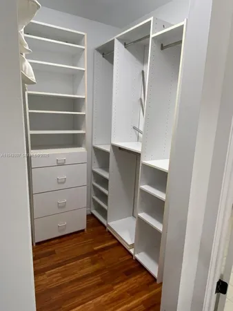 a view of walk in closet with empty racks