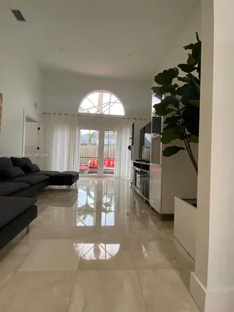 a living room with furniture a fireplace and a chandelier