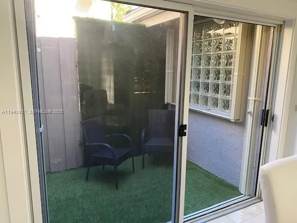 a view of a bathroom with a glass door and a bath tub