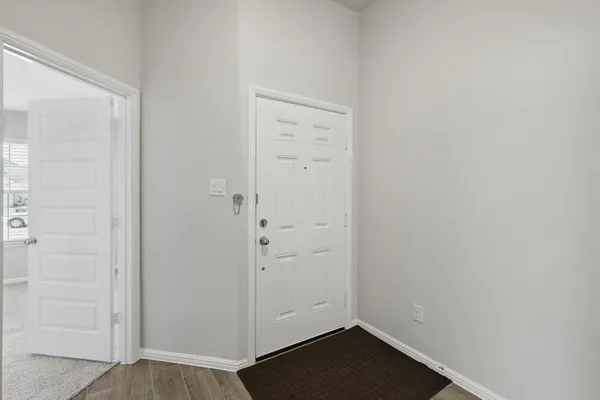 an empty room with wooden floor