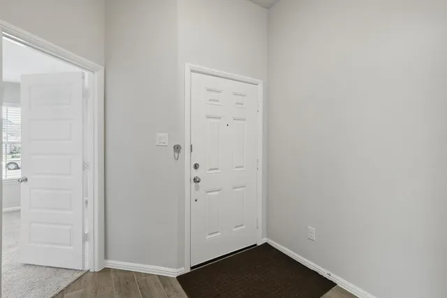 an empty room with wooden floor