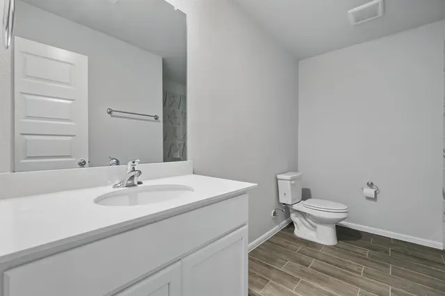 a bathroom with a sink toilet and vanity