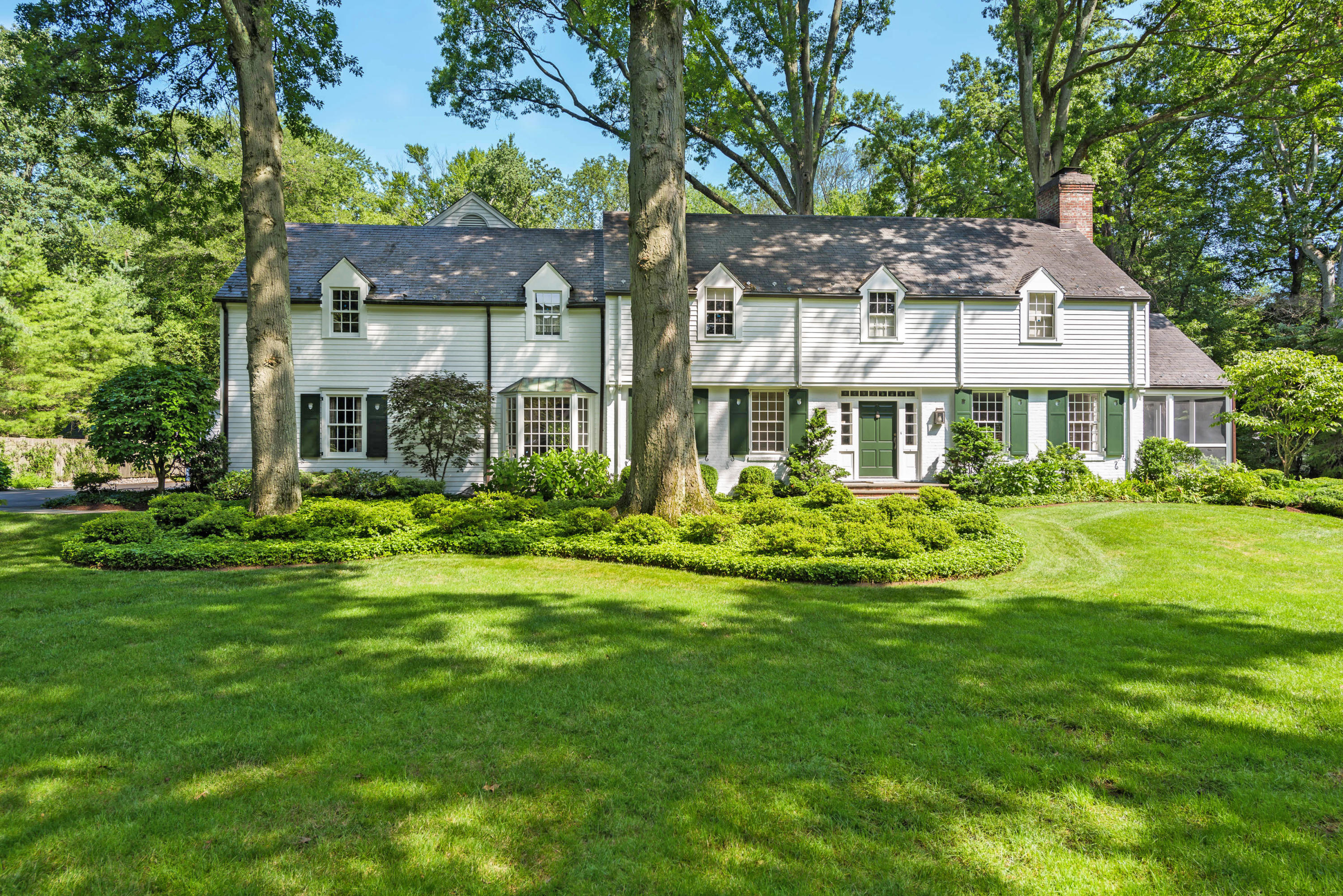 41 St Nicholas Road Darien, CT 06820 - Photo 1 of 39 a front view of a house with a yard table and chairs